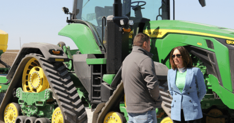 Brooke Rollins talking to a farmer